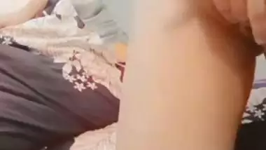 The naked girl fingers her wet pussy during a video call sex