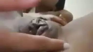 An Indian nude girl fingers her shaved pussy and ass